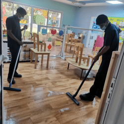 two men doing deep cleaning on the floor by using tools