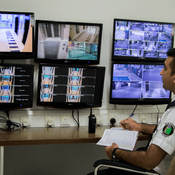 security guard is sitting on the chair watching cctv and identify the issues