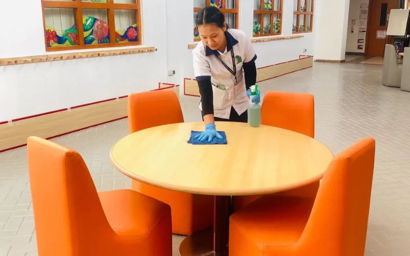 cleaner cleaning on the table with the fabric cloth